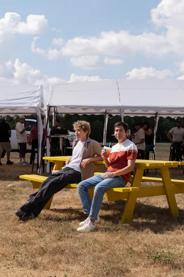 Guests relaxing at picnic tables at the Paradise Live Labor Day Motorcycle & Car Show